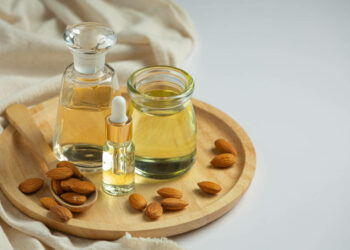 Almond oil in bottle on white background