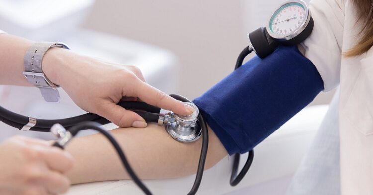 healthcare, hospital and medicine concept - doctor measuring blood pressure from her patient close up