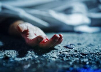 Extreme Close-Up on Victim's Bloody Hand. Still Dead Body Under a Cover and Next to Numbered Markers. Spilled Blood on the Floor Suggests a Violent and Shocking Crime of Passion in Urban City