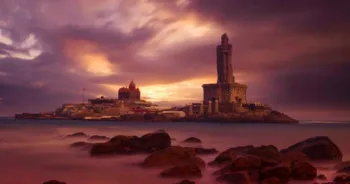 Kanyakumari - Vivekananda Rock Memorial Thiruvalluvar Statue in the evening with a colorful and cloudy sky background.