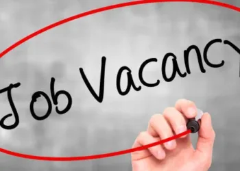 Man Hand writing Job Vacancy with black marker on visual screen. Isolated on background. Business, technology, internet concept. Stock Photo