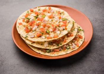 Masala Papad or papadum is a delicious Indian snack made using roasted or fried papad topped with a tangy and spicy onion tomato mix