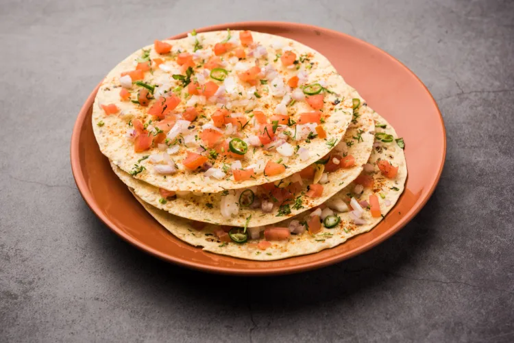 Masala Papad or papadum is a delicious Indian snack made using roasted or fried papad topped with a tangy and spicy onion tomato mix