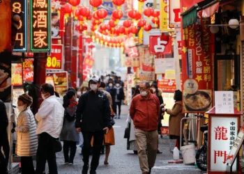 Passersby wearing protective face masks walk on the street at Yokohama's China town, amid the coronavirus disease (COVID-19) outbreak, in Yokohama, south of Tokyo, Japan December 1, 2020.  REUTERS/Issei Kato