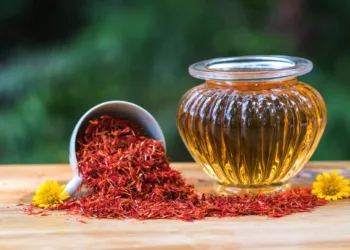 Safflower  oil  in  glass  bottle  on  wooden