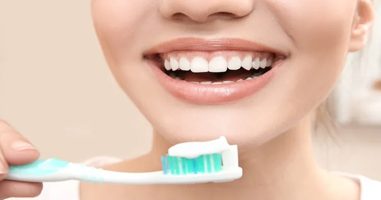 Beautiful woman brushing teeth, closeup