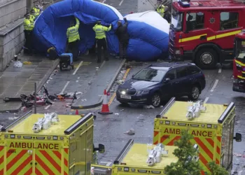 Police and emergency personnel deal with an incident after a car collided with pedestrians near the Liver Building during the Premier League winners parade in Liverpool, England, Monday, May 26, 2025.(AP Photo/Jon Super)