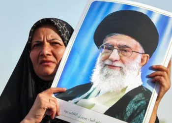 An Iranian woman holds a portrait of supreme leader Ayatollah Ali Khamenei as people celebrate a ceasefire between Iran and Israel at Enghlab Square in the capital Tehran on June 24, 2025. A fragile ceasefire in the Iran-Israel war appeared to be holding on June 24, after 12 days of strikes that saw Israel and the United States pummel the Islamic republic's nuclear facilities. (Photo by ATTA KENARE / AFP)