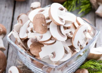 Portion of sliced Mushrooms on wooden background