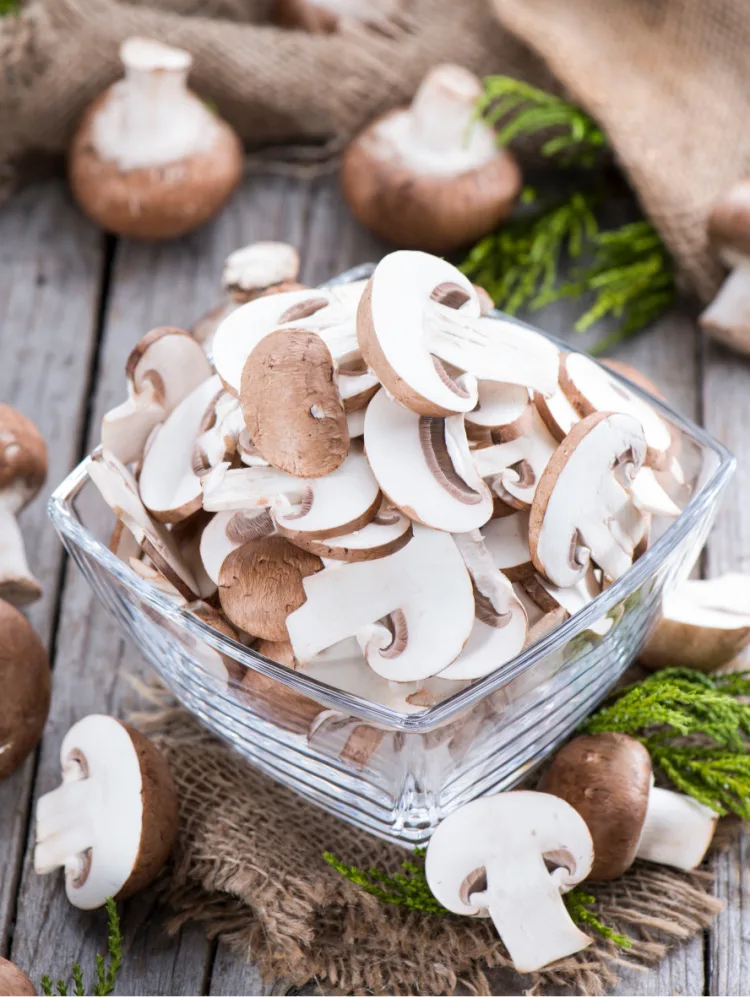 Portion of sliced Mushrooms on wooden background