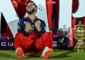 TOPSHOT - Royal Challengers Bengaluru's Virat Kohli reacts while sitting beside the trophy after winning the Indian Premier League (IPL) Twenty20 final cricket match against Punjab Kings at the Narendra Modi Stadium in Ahmedabad on June 4, 2025. (Photo by Arun SANKAR / AFP) / -- IMAGE RESTRICTED TO EDITORIAL USE - STRICTLY NO COMMERCIAL USE --