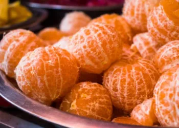 Lots of fresh ripe peeled oranges, good source of vitamin C, immunity booster fruit