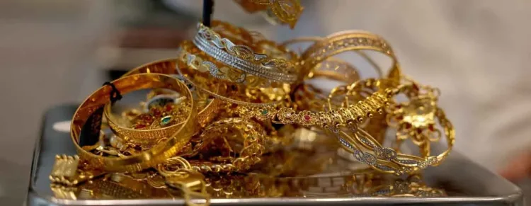 FILE PHOTO: A goldsmith weighs gold jewellery inside a showroom in Ahmedabad, India, July 31, 2025. REUTERS/Amit Dave/File Photo