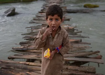 An Afghan refugee boy looks as he crosses a temporary wooden bridge at Jalala refugee camp in district Mardan on April 2, 2014. More than five million Afghan refugees fled war, oppression and poverty, mostly for Pakistan and Iran, in the past three decades. (A Majeed/AFP/Getty Images)